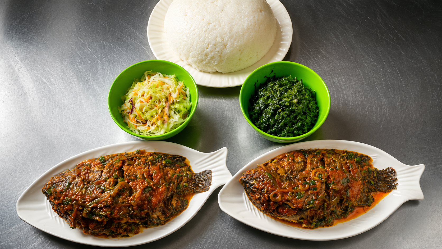 Two wet fry fish plates with ugali and vegetables