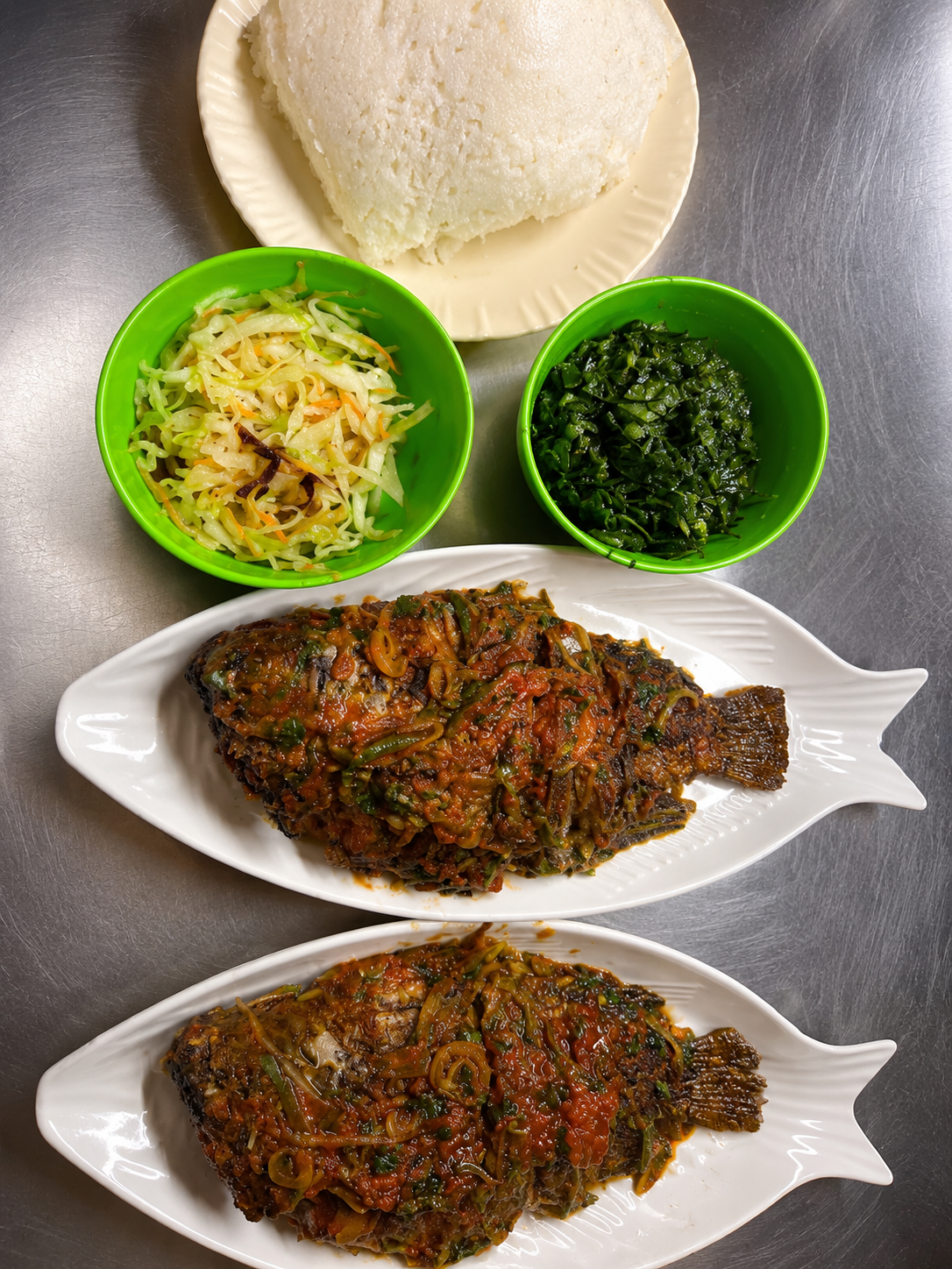 Fish plates with ugali, vegetables and greens